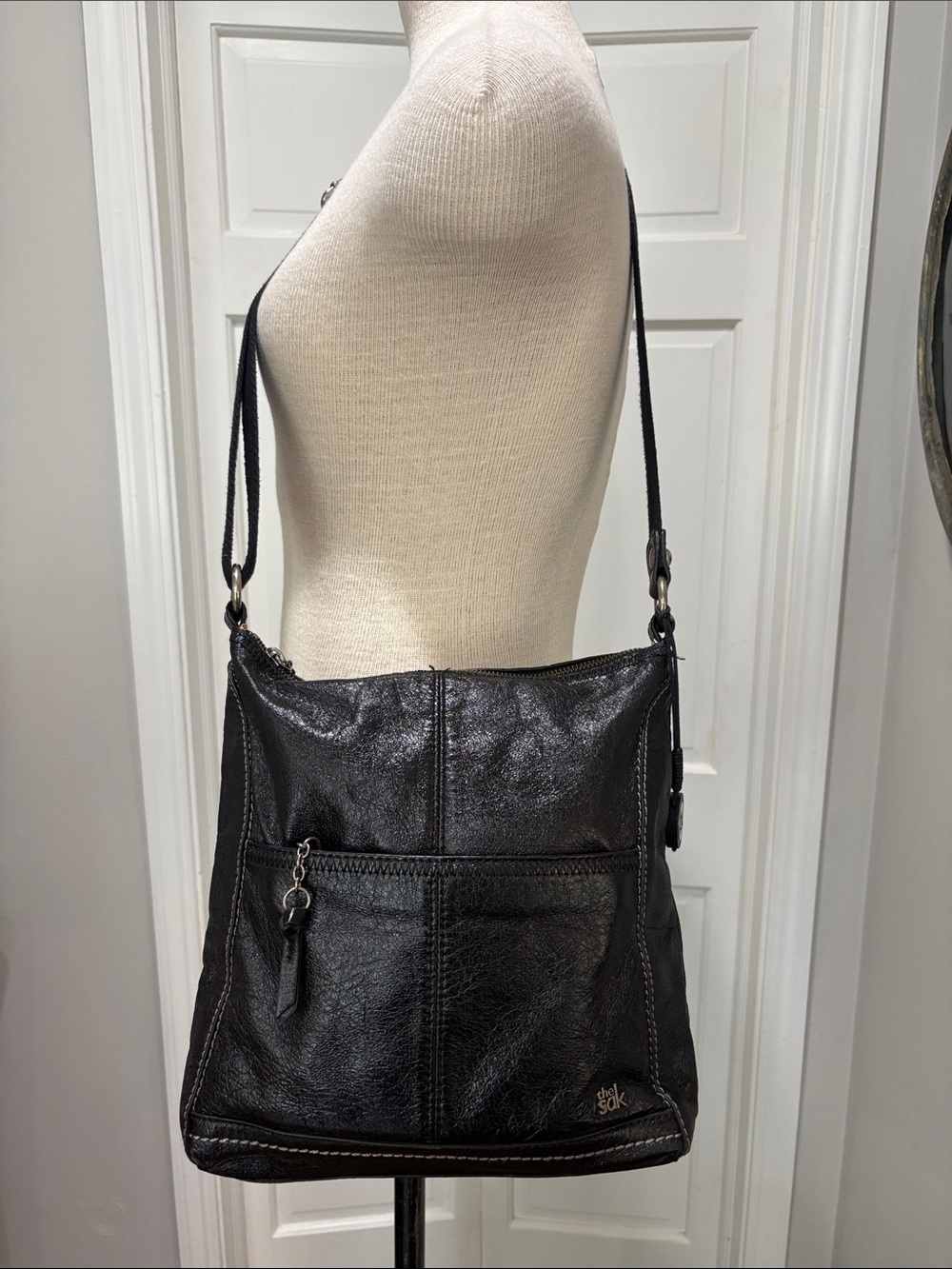 The Sak black leather crossbody purse with adjustable strap.